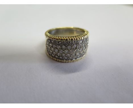 An 18ct yellow and white gold diamond encrusted ring, approx 10.3 grams, marked 18ct 750, ring size P, small usage marks but 