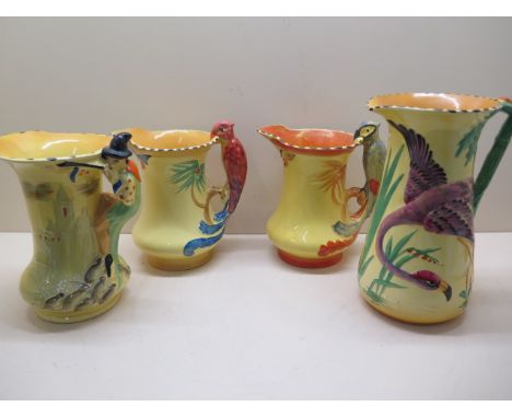 Four Burleigh ware pottery jugs; Pied Piper, 21.5cm tall; two with 'parrot' moulded handles and one taller jug moulded with a