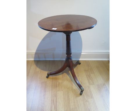 A Regency tilt top mahogany side table on a ring turned stem and out splayed tripod base, 72cm tall x 51cm diameter, in good 