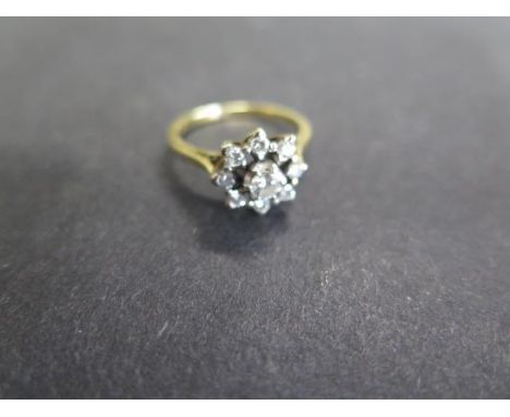 A hallmarked 18ct gold platinum and diamond cluster ring, size O, diamonds bright, hallmarks worn, centre diamond approx 0.15