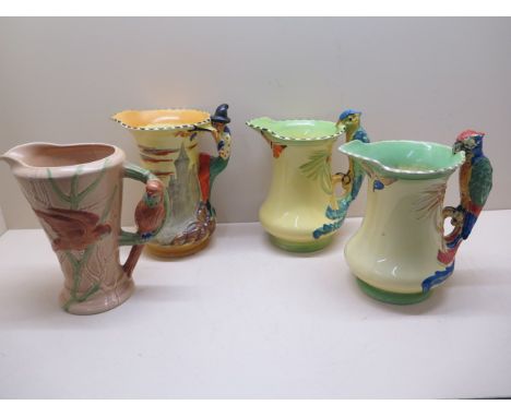 Four Burleigh ware pottery jugs; The Pied Piper, 21.5cm tall, and three jugs with parrot moulded handles, one parrot jug has 