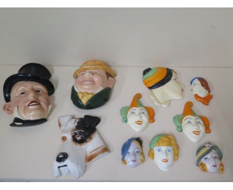 A collection of 10 ceramic wall face plaques, largest 23cm tall to smallest 7cm, chips to backs of 2 small lady masks, others