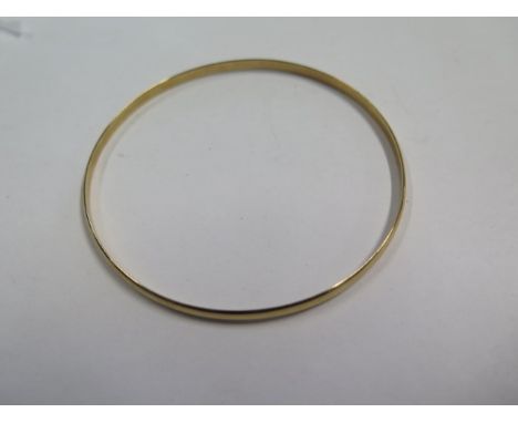 A hallmarked 9ct yellow gold bangle 7cm external diameter, approx 7.7 grams in generally good condition 
