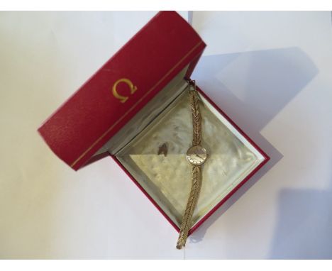 A 9ct yellow gold Omega ladies manual wind bracelet watch, 18mm case, marked 9 375, total weight approx 21 grams, with spare 