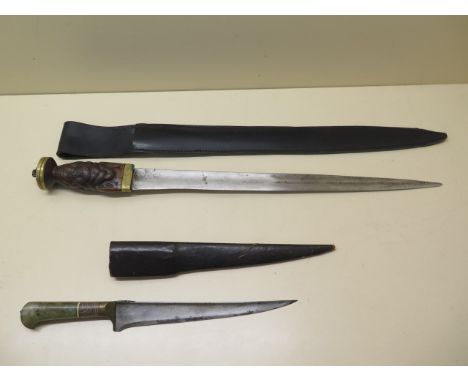 A hunting dagger with a well carved hilt, 50cm long, split to grip and wear to blade, possible replacement pommel, and scabba