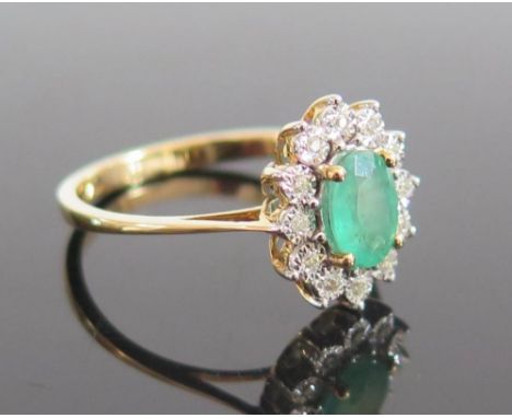 An 18ct Gold Emerald and Diamond Ring, size N.5