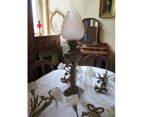A Brass Paraffin Lamp with foliate pressed glass shade, 69 cm to top of shade