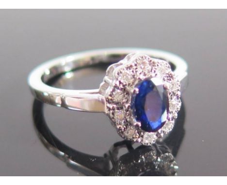 An 18ct White Gold Sapphire and Diamond Ring, size K.5