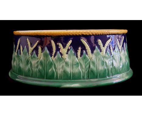 A George Jones maholica game pie dish base, decorated with wheat ears, impressed JG mark, indistinctly numbered in black