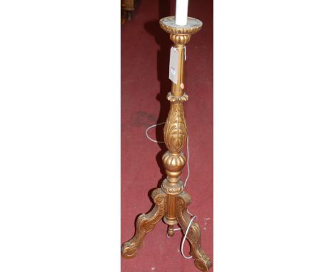 A gilt decorated and low relief floral carved standard lamp in the Italian taste