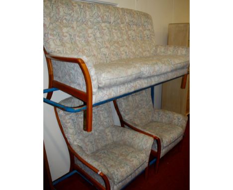 An Ercol light elm and floral buttonback upholstered three piece suite comprising; triple sofa and pair of armchairs