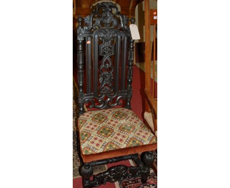 A Carolean style carved and ebonised oak single dining chair having bright coloured tapestry stuff over seat