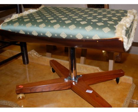 A 1960s hardwood and aluminium footstool, raised on roller casters