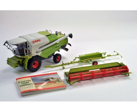 Universal Hobbies Farm issue comprising 1/32 Claas Tucano 450 Combine with header trailer plus combine book. Unboxed, some di