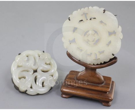 Two Chinese pale celadon jade bi discs, 18th/19th century, the first of a Song dynasty design of entwined chi-dragons, diamet