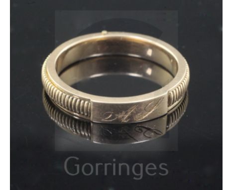 A Victorian milled gold hinged twin compartment mourning band, with engraved monogram, the two hinged arms opening to reveal 