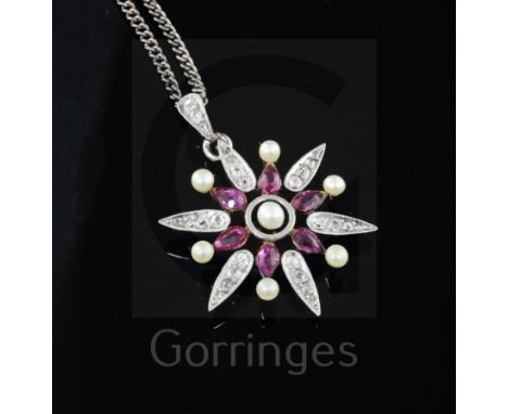 An Edwardian gold and silver, ruby, diamond and seed pearl flower head pendant, on a later silver chain, 26mm.