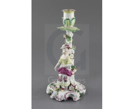 A Derby 'Pale Family' candlestick figure, c.1756-8, modelled with a girl holding a flower in her left hand, flower encrusted 