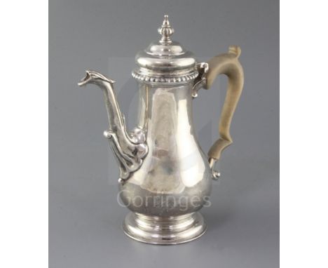 A modern George II style coffee pot by Rodney C. Pettit, of baluster form, with leaf capped spout and turned finial, London, 