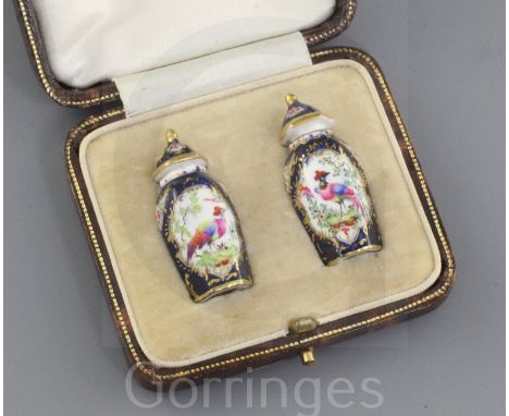 A pair of Royal Worcester miniature hexagonal scale blue jars and covers, c.1910, each painted with an exotic bird in a lands
