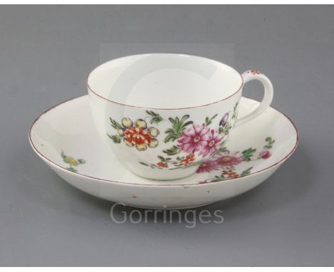 A rare Derby cup and saucer, c.1758, painted in 'Cotton-stem painter' style with a loose bouquet of flowers and floral sprays
