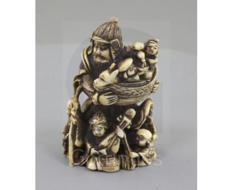 A Japanese ivory netsuke of Bishamon Ten, Meiji period, standing and holding a miniature of the Gods of Good fortune, unsigne