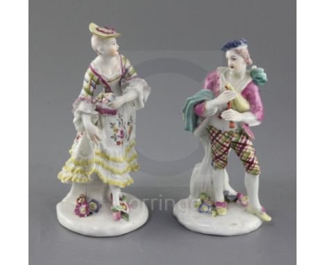 A pair of early Derby figures of a bagpiper and female companion, c.1756-7, each wearing tartan patterned clothing, the young