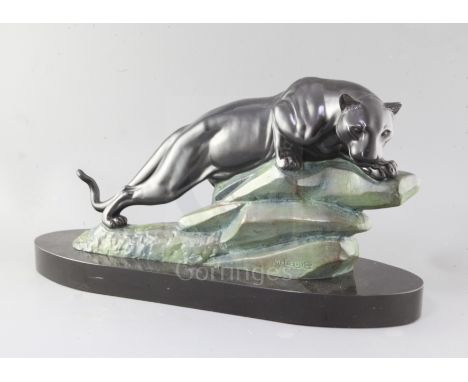 M. LeDucq. An Art Deco patinated spelter model of a panther upon a rock, signed, on oval black marble plinth, 23in.