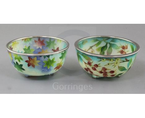 Two Japanese plique a jour enamel bowls, the first decorated with branches laden with berries and the second with maple leave