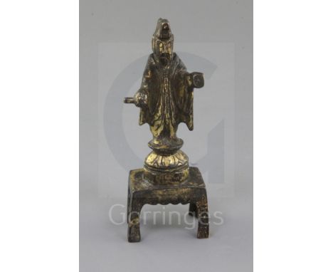 A small Chinese gilt bronze figure of a Daoist deity possibly Yuanshi Tianzun, Tang dynasty (AD 618-907), holding a scroll an