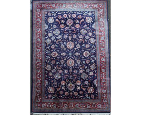 A Tabriz blue ground carpet, with field of scrolling foliage and multi row border,