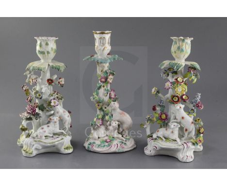 Three early Derby candlestick groups, c.1758-60, two of the candlesticks modelled with two sheep, one climbing a tree, on fou