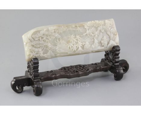 A Chinese pale grey jade plaque, carved in high relief with three sages seated at a table in a landscape, 28.5 x 10cm excludi