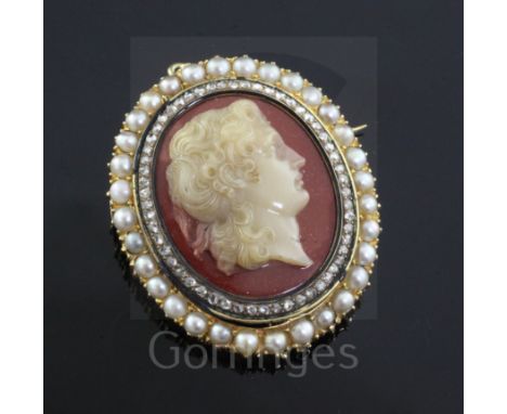 A 19th century gold, diamond and split pearl mounted oval hardstone cameo pendant brooch, carved with the bust of a lady to s