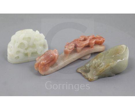 Three Chinese jade carvings, Qing dynasty, the first in pale celadon jade a hat finial carved in openwork with deer amid tree