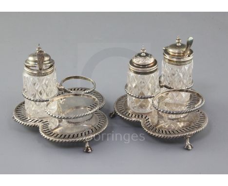 A pair of Victorian silver three division cruet stands by Edward Hutton, with engraved inscription, London, 1888 and three as