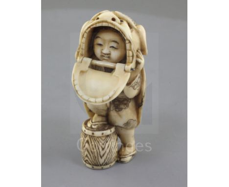 A Japanese ivory netsuke of a shishimai dancer, Meiji period, signed Nagatame, with one foot on a drum, articulated dragon ja