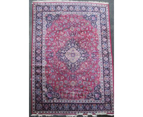 A Meshed red and blue ground, carpet 5.03 x 3.43 with central medallion in a field of floral motifs, with three row border, 5