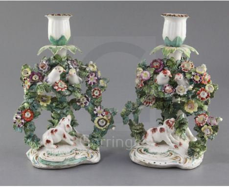 Two matching Derby candlestick groups, c.1765, modelled with birds perched in a flower encrusted bower, with a barking spanie