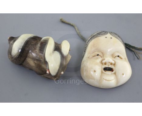 Two Japanese netsuke, the first of an ivory mask of Okame, Meiji period, stained detail and two character signature, 3.7cm an