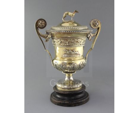 A handsome George III silver gilt two handled presentation pedestal trophy cup and cover by William Elliot, of campana form, 