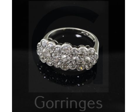 An 18ct gold, platinum and diamond set triple flower head cluster ring, set with old cut stones, size M.