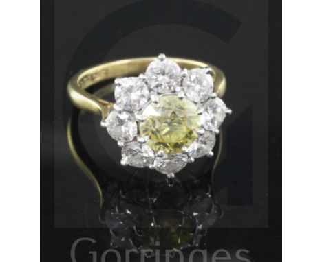 A 1960's 18ct gold and diamond cluster ring by Cropp &amp; Farr, the central fancy yellow stone weighing approximately 1.40ct