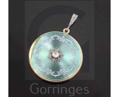An Edwardian 18ct gold, guilloche enamel and diamond set circular pendant locket, with scroll decoration, Frankfeld Freres, L