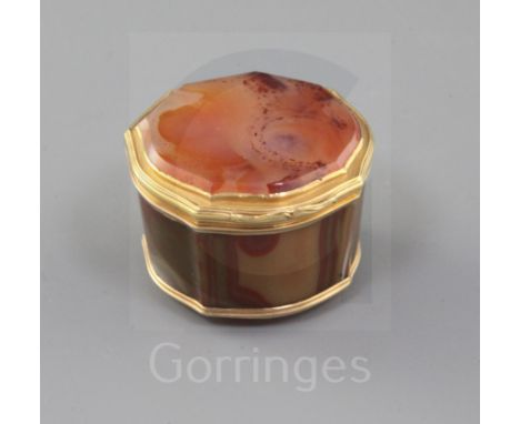 A late 18th/early 19th century Swiss? gold mounted banded agate shaped circular pill box, 43mm.