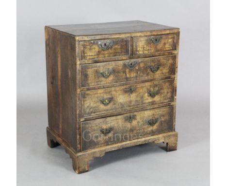 A George III feather banded fruitwood chest of two short and three graduated long drawers, on bracket feet, W.2ft 5in. D.1ft 