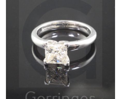 A modern 18ct white gold and solitaire princess cut diamond ring, the stone weighing approximately 1.50cts, with an estimated