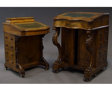 A large Victorian walnut Davenport, with sloping leather inlaid top, above double cupboard doors, with four dummy drawers to 