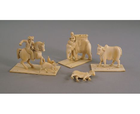 A group of Indian ivory carvings, late 19th/early 20th century, to comprise a pair of humped oxen, an elephant and rider and 