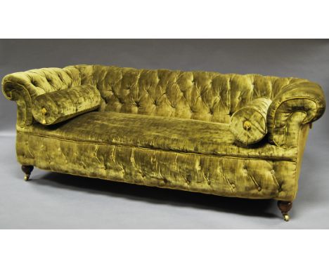 A Victorian mahogany chesterfield sofa, with overstuffed button back bottle green chenille upholstery, on turned legs, with b